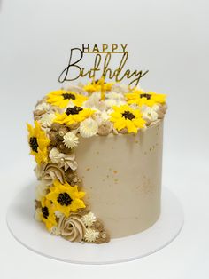 a birthday cake with yellow and white flowers on it