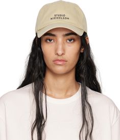 Cotton twill cap in beige. · Embroidered eyelets at crown · Logo embroidered at face · Curved brim · Cinch fastening Supplier color: Sand Beige Flat Brim Hat With Embroidered Logo, Beige Snapback Dad Hat With Embroidered Logo, Beige Embroidered Visor Hat, Beige Dad Hat With Embroidered Logo And Curved Brim, Beige Baseball Cap For Spring Streetwear, Cream Curved Brim Baseball Cap With Embroidered Logo, Cream Baseball Cap With Embroidered Logo, Studio Nicholson, Crown Logo