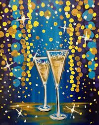 two champagne glasses on a table with confetti falling from the sky in the background