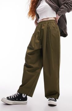 Made from lightweight cotton, these roomy pants feature an elastic waist, front pleats and curved balloon legs. Elastic waist Front slant pockets 100% cotton Machine wash, line dry Imported Spring Utility Wide Leg Pants With Elastic Waistband, Utility Style Cotton Wide Leg Pants With Elastic Waistband, Oversized Cotton Harem Pants Ankle-length, Baggy Green Wide Leg Pants With Elastic Waistband, Green Relaxed Fit Pants With Elastic Cuffs, Baggy Solid Color Cotton Harem Pants, Green Relaxed Fit Parachute Pants With Elastic Waistband, Green Parachute Pants With Elastic Waistband, Relaxed Fit, Green Parachute Pants With Relaxed Fit And Elastic Waistband