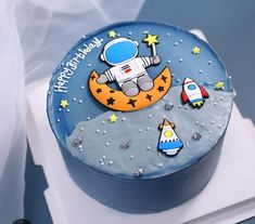 a birthday cake with an astronaut on the moon