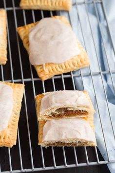 four pastries on a cooling rack with frosting