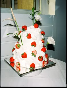 a large white cake with strawberries on it