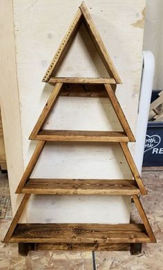 a wooden christmas tree sitting on top of a table