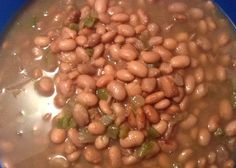 beans are being cooked in a pot on the stove