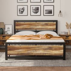 a bed with wooden headboard and foot board in a room decorated with pictures on the wall