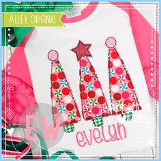 three christmas trees on a white shirt with pink and green trimmings, surrounded by other holiday items