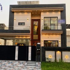 the front view of a modern house with black and white accents