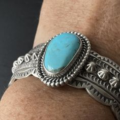 This stunning sterling silver heavy weight ocean blue Kingman turquoise cuff is made by a Navajo artist Wydell Billie and is hallmarked with his stamp. The inside measures 5.5" and the gap measures 1 3/8". Because of the weight of the bracelet it can not be adjusted. It is ideal for a 6.75-7" wrist at the current size. The widest spot at the stone measures 1.25". Western Turquoise Stamped Cuff Bracelet, Western Style Stamped Turquoise Cuff Bracelet, Turquoise Stamped Western Cuff Bracelet, Turquoise Western Stamped Cuff Bracelet, Western Style Blue Sterling Silver Bracelet Gift, Southwestern Sterling Silver Cuff Bracelet In Blue, Southwestern Blue Concho Bracelets, Western Style Blue Sterling Silver Collectible Bracelet, Western Style Blue Sterling Silver Bracelet Collectible