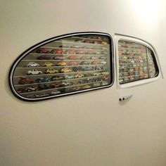 there is a display in the wall with cars and trucks on it's sides