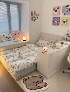 a bed room with a neatly made bed and a teddy bear rug on the floor