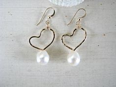 "These hand-formed and hand-hammered 14k gold-filled artistic heart earrings feature beautiful 8mm-9mm WHITE Freshwater Keishi Pearls below. You may choose between Sterling Silver ($55) and 14k Gold-Filled ($65-Shown) and also any other pearl color of your choice by using the drop-down menu at checkout. Choose between: Midnight Blue, Red, Pink, White (Shown), Chocolate Brown, or Champagne. *These are Keishi pearls, which have a more organic shape that features a more-rounded front side and a fla Heart Pearl Earrings, Pearl Heart Earrings, Gold Heart Earrings, Pearl Earrings Gold, White Pearl Earrings, Gold Heart Earring, Long Gold Earrings, Love Earrings, Simple Pearl