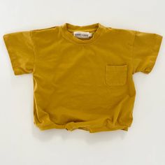 Cory Pocket Romper in Mustard | Baby and Toddler | WinnieandCrew.com – Winnie + Crew Unisex Short Sleeve T-shirt For Playwear, Cotton Short Sleeve Bodysuit For Summer, Cotton Tops With Pockets For Playtime, Basic Cotton Short Sleeve Bodysuit For Summer, Unisex Casual Short Sleeve Bodysuit For Playwear, Solid Short Sleeve Bodysuit For Loungewear, Cotton Tops With Pockets For Playwear, Cotton Short Sleeve Bodysuit For Playtime, Relaxed Fit Short Sleeve Bodysuit For Summer