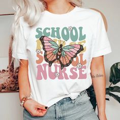 "School Nurse Shirt, Smile School Nurse Shirt, Elementary School Nurse Sweatshirt,Nurse Appreciation Gifts,Back to School Last Day of school Welcome to Macievision Shop! I am so happy to see you here. HOW TO ORDER 1. Select the shirt 𝗦𝘁𝘆𝗹𝗲 2. Select the 𝗦𝗶𝘇𝗲, Color 3. Fill the Personalized information (if any) 4. Select the quantity, 5. Click 𝗔𝗗𝗗 𝗧𝗢 𝗖𝗔𝗥𝗧. If you want to buy more than one, please go back to the listing and repeat the steps. \"If you have any question, please send us a message.\" BRAND If you want a specific brand, please send us a message right after you place the order. Otherwise, we will send you the t-shirt according to what we have in stock. SIZE CHART We suggest you choose the size you usually wear. They are true to size. CARE INSTRUCTIONS Turn the sw White Retro T-shirt For Back To School, White Retro T-shirt For School, Retro White T-shirt For School, Retro White Tops For Back To School, School Nurse Shirt, School Last Day, School Nurse Office, Sweater Drying Rack, Nurse Office