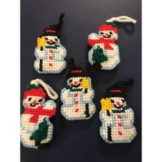 four snowman ornament ornaments on a table