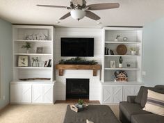 the living room is clean and ready to be used as a family room with built - in bookshelves