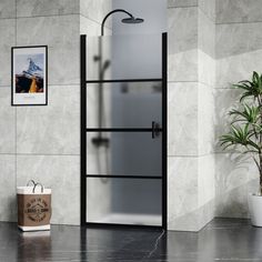 a bathroom with marble walls and flooring next to a potted plant in the corner