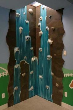 this is an image of a mural in the bathroom with rocks and water flowing down it