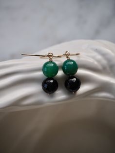 These minimal earrings are perfect every day wear! Smooth, glowing green onyx beads (7mm) on top of facetted black spinel beads (7mm) dangle from simple 14 k gold filled ear hook.  * One-of-a-kind* D e t a i l s: => Metal Type  - 14k Gold Filled => Full length - Approx 3 cm / 1.18" => Bead Type - Green Onyx and Black Spinel I use ONLY 100% recyclable mailers and 100% biodegradable product packaging Lets keep in touch! Follow me on instagram @moyjewelrydesign to find out about the new products an Green Gemstone Round Bead Earrings, Green Gemstone Earrings With Round Beads, Elegant Green Onyx Drop Earrings, Elegant Green Onyx Earrings For Gift, Everyday Green Earrings With Natural Stones, Elegant Black Jade Jewelry, Everyday Green Round Bead Earrings, Everyday Green Round Beaded Earrings, Multiple Earrings