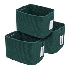 two dark green storage baskets with white labels on them, one is empty and the other has no handles