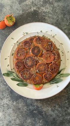 a white plate topped with a pizza covered in toppings next to an orange slice