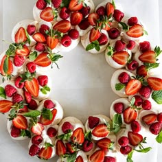 a cake decorated with strawberries and mint leaves