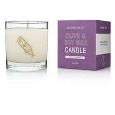 an image of a candle that is in front of a box with the label olive and soy wax candle