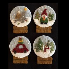 four snow globes with christmas decorations on them