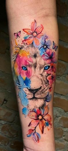 a colorful tattoo with a lion and flowers on the leg, which is painted in watercolor