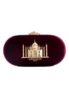 Oxblood oval-shaped clutch embellished with gold-toned Taj Mahal motif. Comes with a detachable chain.
Type: Embellished
Composition: Patent Metallic Leather; Lining: Quilted Silk Satin
Color: Oxblood - Maroon
Oval shaped
Size L (inch) : 8 x 4 x 2
Closure: Metal clasp - Aza Fashions Sabyasachi Collection, Bridal Clutch, Designer Clutch, Lakme Fashion Week, Satin Color, Textiles Fashion, Handbags Online, Online Fashion Stores, Metallic Leather