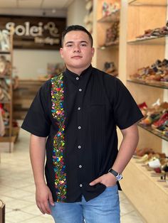 This beautiful Traditional Guayabera for Men is embroidered and adds a sophisticated flare to your wardrobe.  This elegant button up Shirt is perfect for special occasions such as Mexican Fiestas, Quinceañeras, Weddings, etc. This guayabera is handmade and completely hand embroidered by Mexican Artisans in Oaxaca, Mexico. More styles available here: https://www.etsy.com/es/shop/SoleiEthnic?ref=seller-platform-mcnav&section_id=26873542 Traditional Black Shirt With Floral Embroidery, Traditional Black Embroidered Shirt, Traditional Fit Short Sleeve Shirt, Casual Embroidered Shirt Traditional Fit, Casual Embroidered Shirt With Traditional Fit, Traditional Short Sleeve Shirt With Multicolor Embroidery, Traditional Fit Embroidered Shirt For Spring, Mexican Men, Men Formal