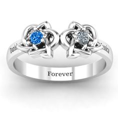 two heart shaped rings with the words forever and blue sapphire stones on each band, set in