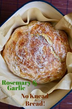 a close up of a bread in a pan on a table with text overlay that reads rosemary garlic no knead bread