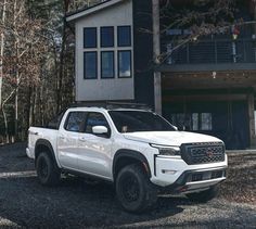 a white truck parked in front of a house