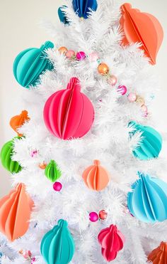 a white christmas tree decorated with colorful ornaments