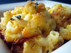 a close up of a plate of food with macaroni and cheese on it