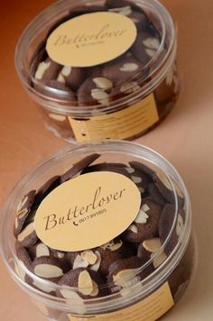 two plastic containers filled with chocolate covered cookies