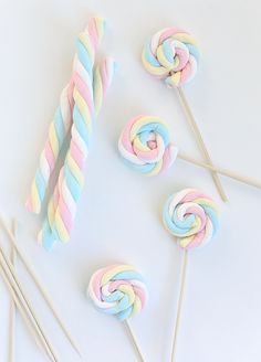 some lollipops and candy sticks on a white table with an instagramr