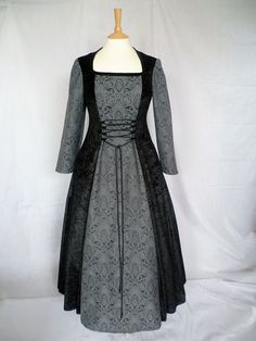 This is for a custom made dress,it will be made to the measurements you send me. Please send me your bust,waist and hip measurement,and please measure from the top of your shoulder to the floor with shoes on. It is made with beautiful black crushed velvet and stunning grey and black jacquard. It will have a corset style front and back with black lacing so you can adjust the dress to fit your body shape. Combined shipping on multiple items. If you purchase express shipping by courier please send me your phone number thank you. Elegant Dresses With Historical Design For Larp, Elegant Historical Design Dress For Larp, Fitted Gothic Gown For Fancy Dress, Gothic Fitted Gown For Fancy Dress, Fitted Medieval Overbust Dress For Fancy Dress, Fitted Gothic Dresses For Medieval Festivals, Gothic Fitted Dress For Medieval Festivals, Gothic Victorian Wedding Dress With Fitted Bodice, Gothic Corset Dress With Historical Design