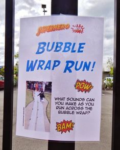 a sign posted on a fence that says bubble wrap run with images of people in the background