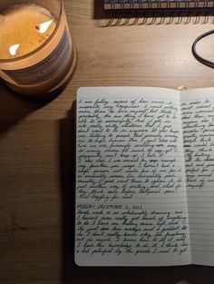 an open notebook sitting on top of a wooden table