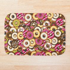 an image of donuts pattern bath mat on the floor with wood floors in the background