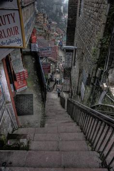 an alleyway with stairs and signs on it