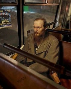 a man with a long beard sitting on a bus