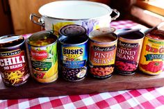 an assortment of canned foods on a wooden tray