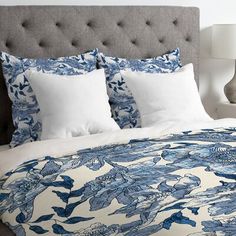 a bed with blue and white floral designs on it