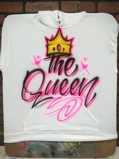 a white t - shirt with the words the queen on it and a yellow crown