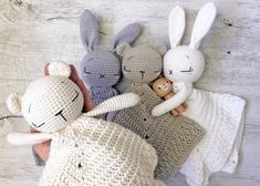 three crocheted stuffed animals laying next to each other on top of a wooden floor