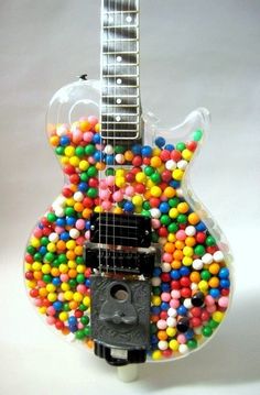 a guitar made out of candy balls and gummy on the top of it's neck