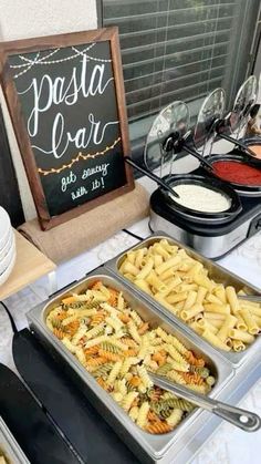 a buffet with pasta and other foods on it